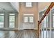Bright foyer with hardwood floors, staircase with wooden banister, and front door access at 2049 Mclain Nw Rd, Acworth, GA 30101