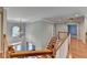 Upstairs hallway with wood floors, staircase, and a light fixture at 2049 Mclain Nw Rd, Acworth, GA 30101