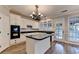 Well-designed kitchen with white cabinets, black countertops, and gray wood-look flooring at 2049 Mclain Nw Rd, Acworth, GA 30101