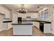 Beautiful kitchen featuring an island with black countertops, white cabinets, and stainless steel appliances at 2049 Mclain Nw Rd, Acworth, GA 30101