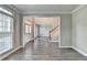 Bright living room with hardwood floors, crown molding, and neutral paint, with a glimpse of the staircase at 2049 Mclain Nw Rd, Acworth, GA 30101