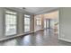 Bright living room with three large windows, hardwood flooring, crown molding, and neutral paint at 2049 Mclain Nw Rd, Acworth, GA 30101