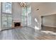 Open living room with a brick fireplace, high ceilings and large windows at 2049 Mclain Nw Rd, Acworth, GA 30101