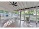 Covered screened-in porch with ceiling fan offers relaxing outdoor living space at 2049 Mclain Nw Rd, Acworth, GA 30101