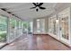 Large screened porch with ceiling fan, multiple entry doors and view of backyard at 2049 Mclain Nw Rd, Acworth, GA 30101