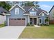 Charming two-story home featuring blue siding, a covered entryway, and a two-car garage at 2438 Whites Rdg, Decatur, GA 30034