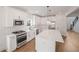 Bright kitchen with white cabinets, a large center island, and stainless steel appliances at 2438 Whites Rdg, Decatur, GA 30034