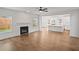 Bright living room featuring hardwood floors, a fireplace, and an open-concept view of the kitchen at 2438 Whites Rdg, Decatur, GA 30034