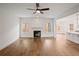 Bright living room with hardwood floors, a fireplace, and views into the kitchen at 2438 Whites Rdg, Decatur, GA 30034