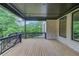 Back deck features a dark wood railing and wood flooring, offering a beautiful view of the treed backyard at 3203 Bold Springs Rd, Dacula, GA 30011