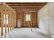 Unfinished basement featuring stud framing and a concrete wall, offering a blank canvas for customization at 3203 Bold Springs Rd, Dacula, GA 30011