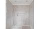 Bathroom shower with tiled walls partially covered in plastic, offering a glimpse of the modern design and clean lines at 3203 Bold Springs Rd, Dacula, GA 30011