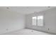 Well-lit bedroom with a window, recessed lighting, and awaiting customization, making it an ideal space for relaxation at 3203 Bold Springs Rd, Dacula, GA 30011