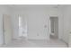 Spacious bedroom with doorways leading to connected rooms, featuring white trim and neutral walls, awaiting personalized touches at 3203 Bold Springs Rd, Dacula, GA 30011