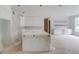 Spacious kitchen featuring a large center island, custom cabinets, and a large window at 3203 Bold Springs Rd, Dacula, GA 30011