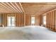 Unfinished living room features a large open space with natural light and a door leading to a deck at 3203 Bold Springs Rd, Dacula, GA 30011