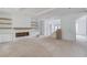 Bright living room featuring a fireplace with custom built-ins and staircase to the upper level at 3203 Bold Springs Rd, Dacula, GA 30011