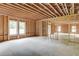 Unfinished living room featuring natural light, exposed beams, and stud framing, ready for customization at 3203 Bold Springs Rd, Dacula, GA 30011