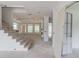 A bright, unfinished living room with stairs and large windows offering natural light at 3203 Bold Springs Rd, Dacula, GA 30011