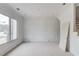 Unfinished living room with paneled walls, large window and natural light at 3203 Bold Springs Rd, Dacula, GA 30011