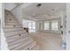Spacious living room under construction with large windows and staircase leading to the second floor at 3203 Bold Springs Rd, Dacula, GA 30011