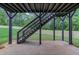 Patio with dark support beams, stairs, and a view of the backyard featuring green grass and a wood fence at 3203 Bold Springs Rd, Dacula, GA 30011