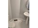 Compact powder room with white pedestal sink and hexagon tile flooring at 4075 Sw Fairburn Sw Ave, Atlanta, GA 30331