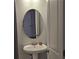 Bathroom featuring a white pedestal sink, oval mirror, and a white door at 4075 Sw Fairburn Sw Ave, Atlanta, GA 30331