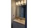 Well-lit bathroom vanity featuring silver hardware, decorative flowers and modern lighting fixture at 4075 Sw Fairburn Sw Ave, Atlanta, GA 30331