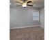 A simple bedroom with a ceiling fan, neutral colored walls, and a window at 4075 Sw Fairburn Sw Ave, Atlanta, GA 30331