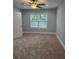 Bright bedroom with a ceiling fan and a window letting in plenty of natural light at 4075 Sw Fairburn Sw Ave, Atlanta, GA 30331