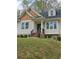 Charming home with a unique shake shingle accent, complemented by a landscaped front yard and stone foundation detail at 4075 Sw Fairburn Sw Ave, Atlanta, GA 30331