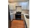 Modern kitchen featuring gray cabinets, granite countertops, stainless steel appliances and wood flooring at 4075 Sw Fairburn Sw Ave, Atlanta, GA 30331
