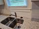 Close-up of a stainless steel sink with granite countertops, complemented by subway tile backsplash at 4075 Sw Fairburn Sw Ave, Atlanta, GA 30331
