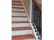 Wooden staircase with white risers and decorative iron railing adds charm to the home at 4075 Sw Fairburn Sw Ave, Atlanta, GA 30331