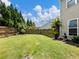 Large, well-maintained backyard with lush green grass and a wooden fence, providing ample space for outdoor activities at 6215 Barley Sq, Sugar Hill, GA 30518