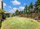 Spacious backyard with a covered patio and a well-manicured lawn, perfect for outdoor entertaining and relaxation at 6215 Barley Sq, Sugar Hill, GA 30518