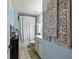 Stylish bathroom featuring decorative wall art, patterned shower curtain, and a neutral color palette at 6215 Barley Sq, Sugar Hill, GA 30518
