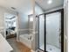 Bright bathroom showcasing a soaking tub, glass-enclosed shower, and stylish fixtures at 6215 Barley Sq, Sugar Hill, GA 30518