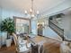 Chic dining area with stylish lighting, wood floors, large mirror and elegant decor, near staircase at 6215 Barley Sq, Sugar Hill, GA 30518