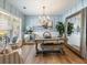 Elegant dining room featuring stylish decor, wood floors, a large mirror, and ample natural light at 6215 Barley Sq, Sugar Hill, GA 30518