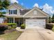 Charming two-story home with a well-manicured lawn, stone accents, and a two-car garage at 6215 Barley Sq, Sugar Hill, GA 30518
