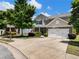 Attractive home with stone accents, a two-car garage, and a nicely landscaped front yard at 6215 Barley Sq, Sugar Hill, GA 30518