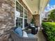 Relaxing front porch with wicker chairs, blue cushions, and stone accents, perfect for outdoor seating at 6215 Barley Sq, Sugar Hill, GA 30518