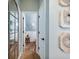 Hallway view leading to a half bathroom with stylish decor and wood-look floors at 6215 Barley Sq, Sugar Hill, GA 30518