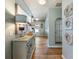 Bright hallway featuring hardwood floors, stylish decor, and access to other areas of the home at 6215 Barley Sq, Sugar Hill, GA 30518