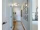Entry hallway with light gray walls, wood floors, and decorative wall art at 6215 Barley Sq, Sugar Hill, GA 30518