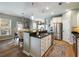 Modern kitchen with a central island, stainless steel appliances, and an adjacent dining area at 6215 Barley Sq, Sugar Hill, GA 30518