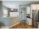 Bright kitchen featuring white cabinets, stainless steel refrigerator and an eat-in area at 6215 Barley Sq, Sugar Hill, GA 30518