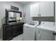 Practical laundry room with washer, dryer, and ample storage space at 6215 Barley Sq, Sugar Hill, GA 30518